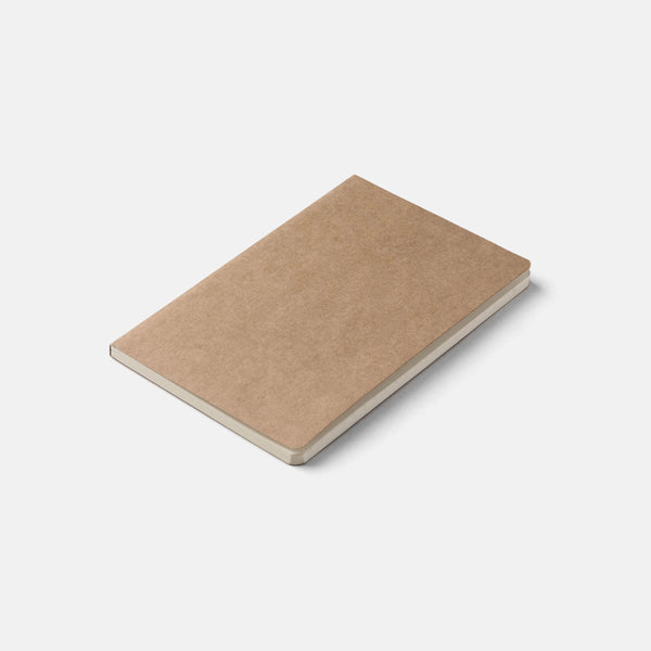 Beige pocket size notebook on a light gray background